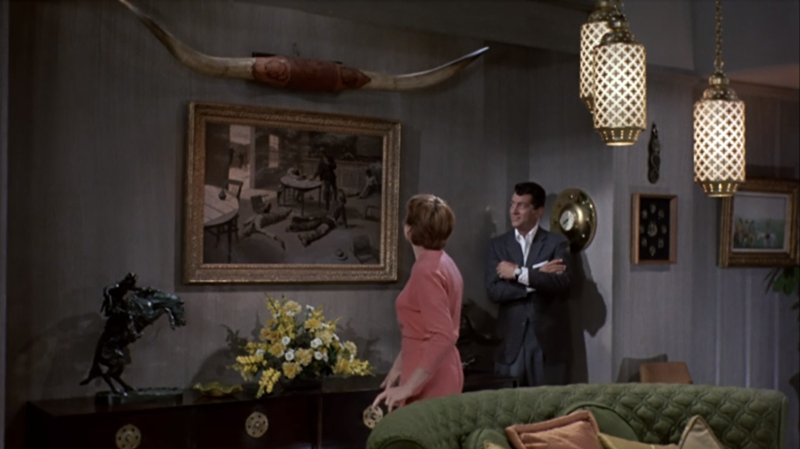 Dean Martin and Shirley MacLain admire A Misdeal by Frederic Remington in All in a Night's Work, 1961