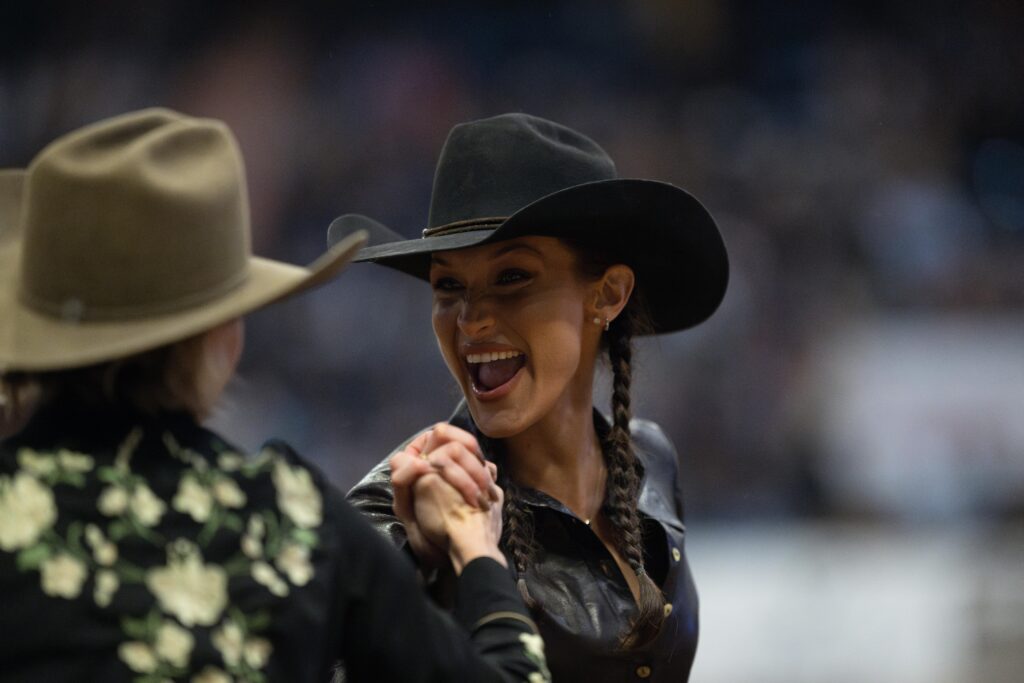 Bella Hadid gives partner Jen Landon a hand.