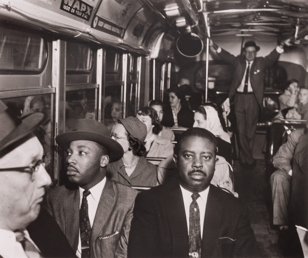 Ernest C. Withers, Dr. Martin Luther King Jr. and Rev. Ralph David Abernathy ride on one of the first desegregated buses.1956.