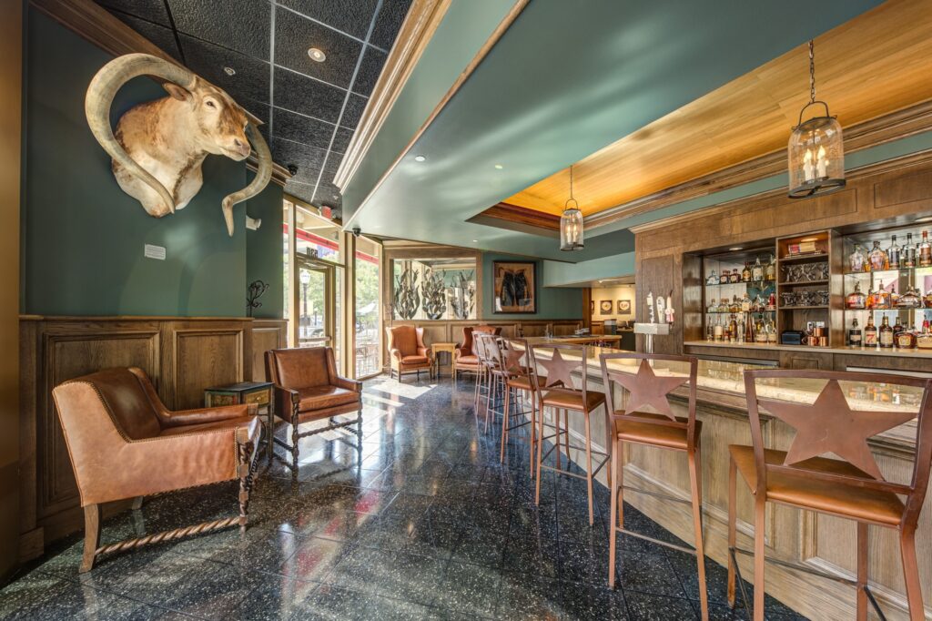 The arched, marble topped bar greets visitors